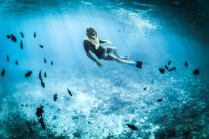 Snorkeling in clear water with fish Zanzibar